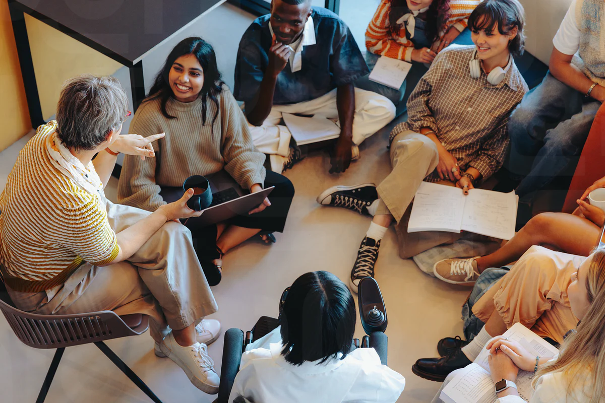Teacher working with students in classroom discussion